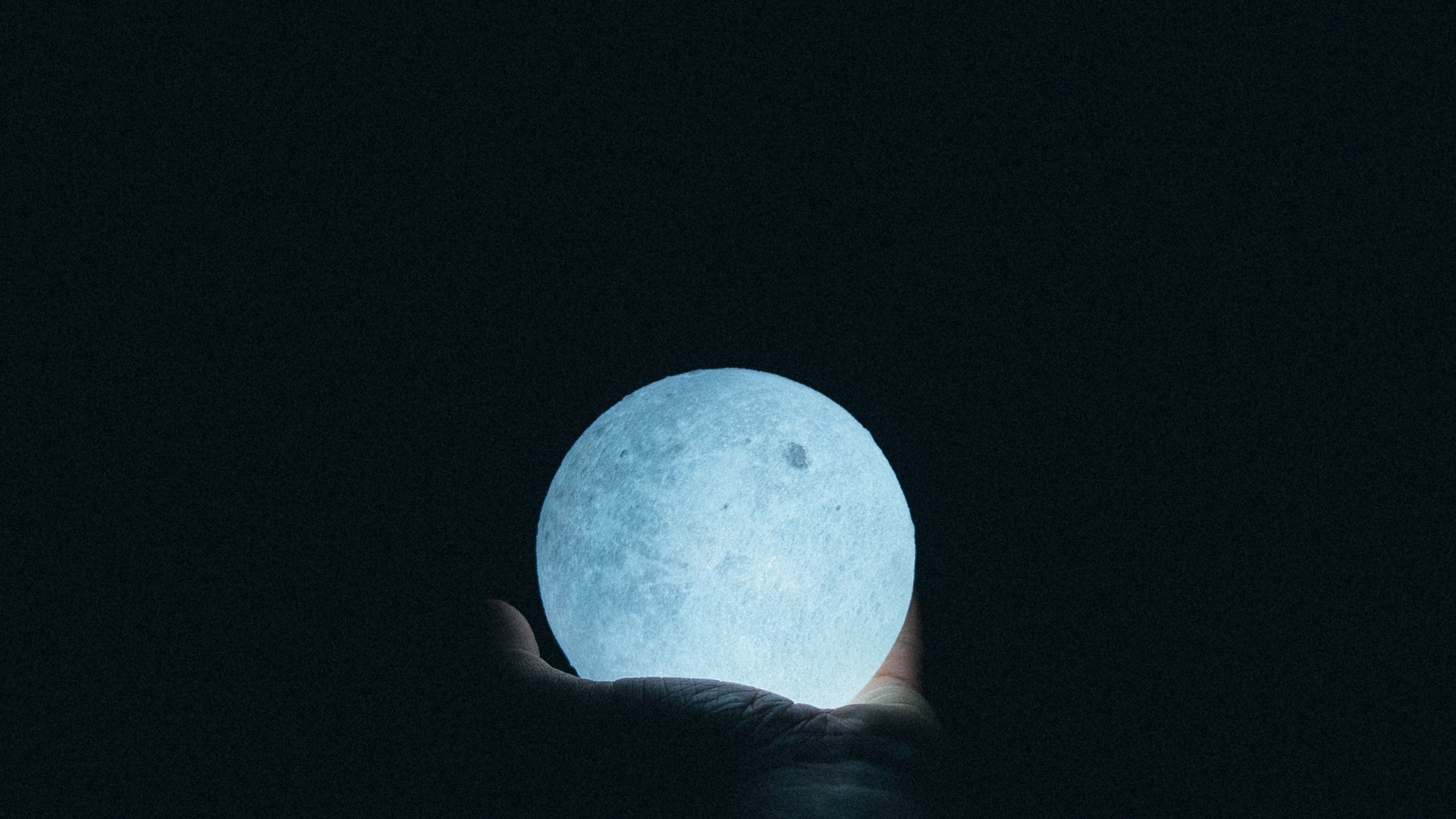 Close Up Photo Of Person Holding Moon Lamp