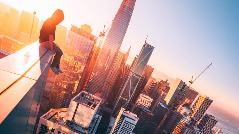 A Person Sitting On The Top Of A Tall Building - Wallpaper Download