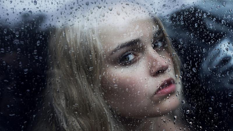 Girl Behind The Glass With Water Drops