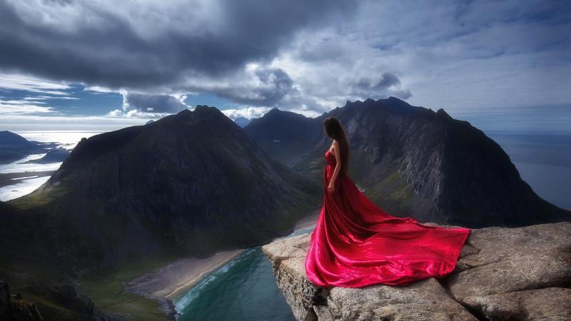 Girl In Red Dress Standing On The Edge Of Mountain Cliff
