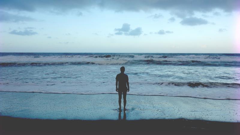 Man Standing At Ocean Shore