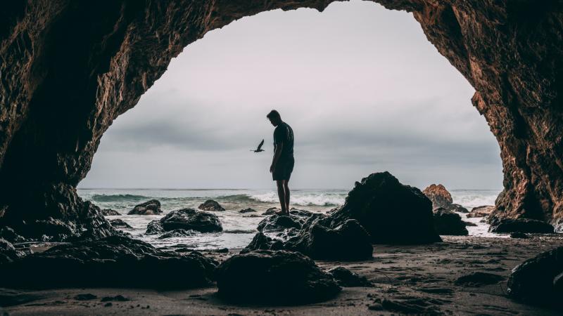 Man Standing In Front Of Cave 8k