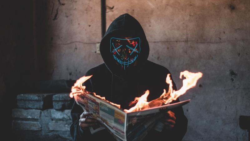 Mask Guy Reading A Burning News Paper