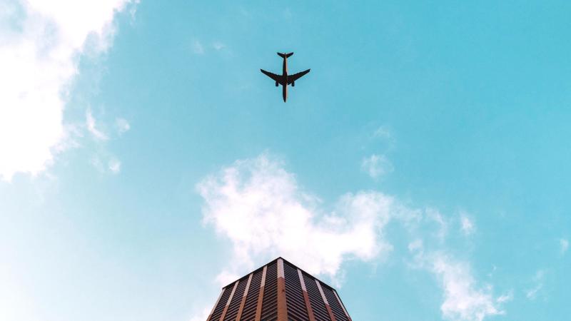 Plane Flying Over Building 4k
