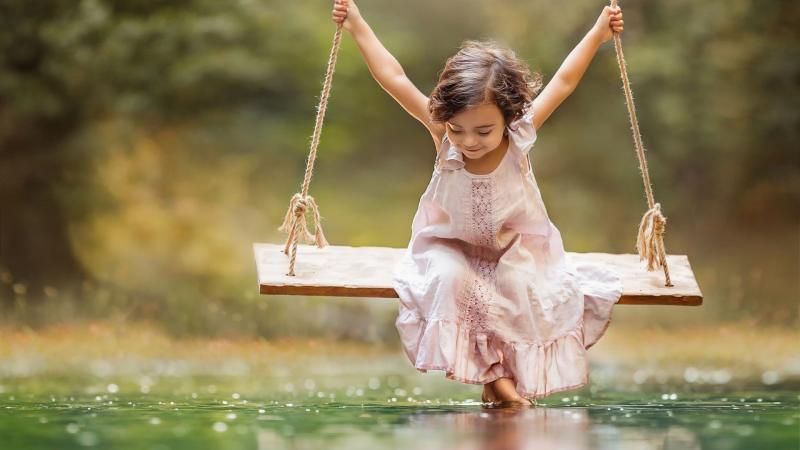 Small Girl Taking Swing