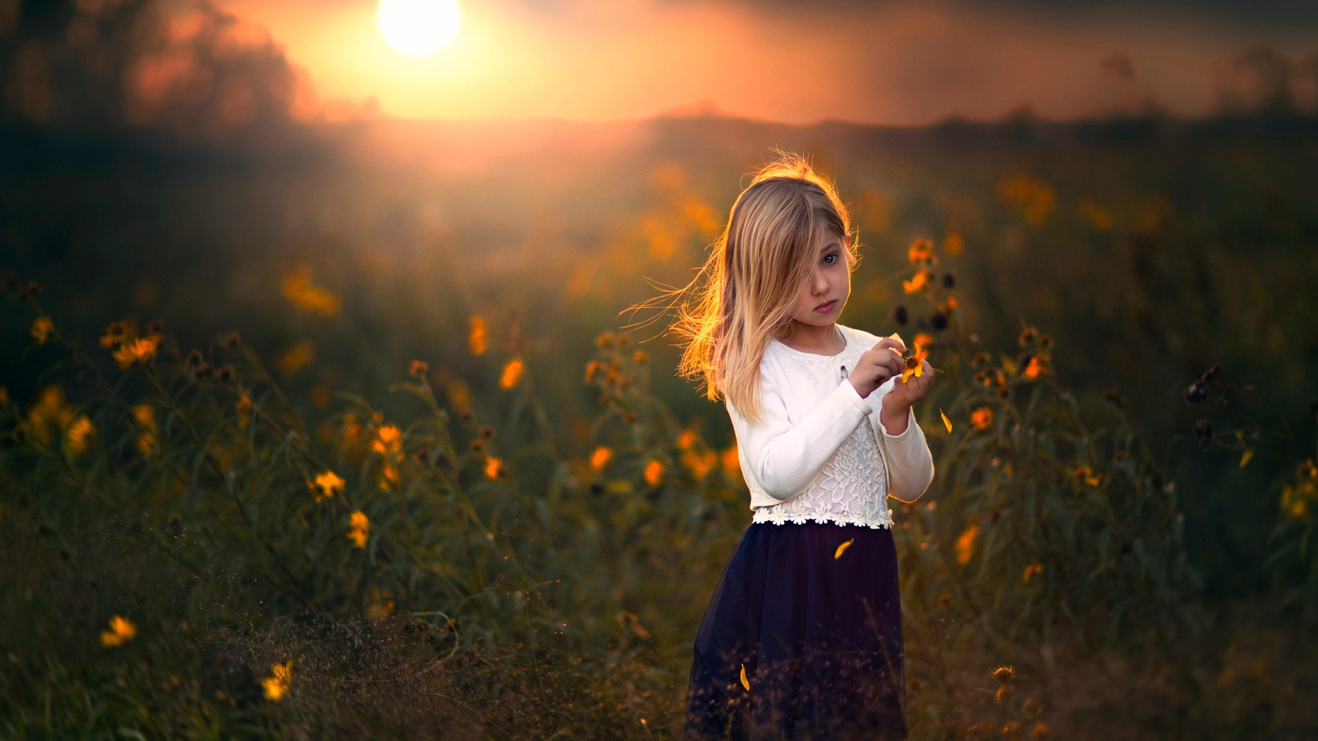 Cute Child Girl With Flowers Outdoors