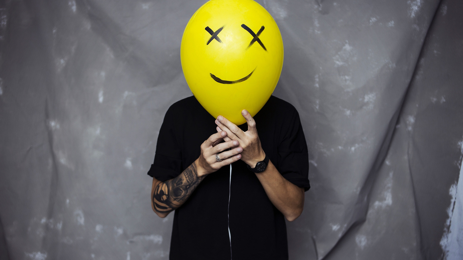 Boy With Smiley Balloon On Face
