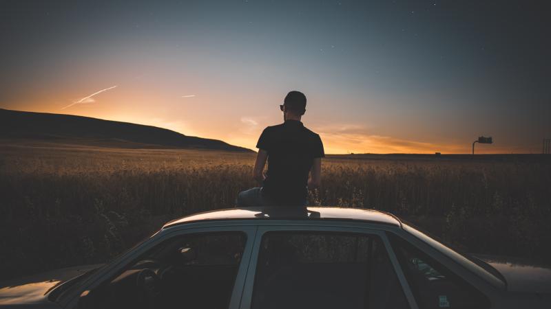 Boy Sitting On Top Of Car Watching Nature View 5k