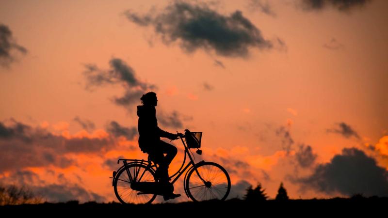 Cyclist Chasing Sky