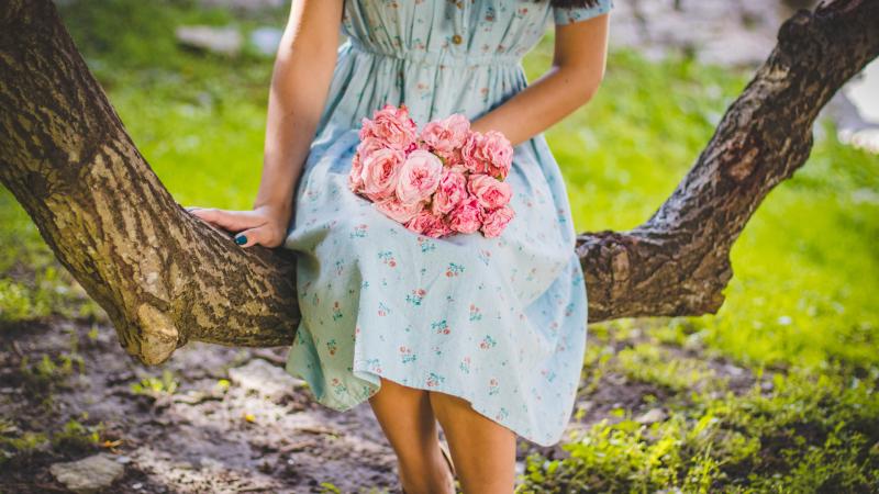 Girl Sitting Flowers In Hand