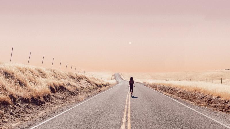 Girl Walking Alone On Desert Road