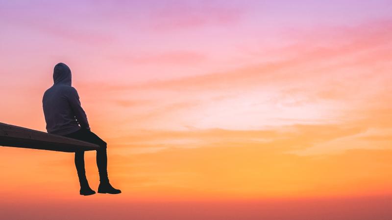 Man Watching Sunset On Top