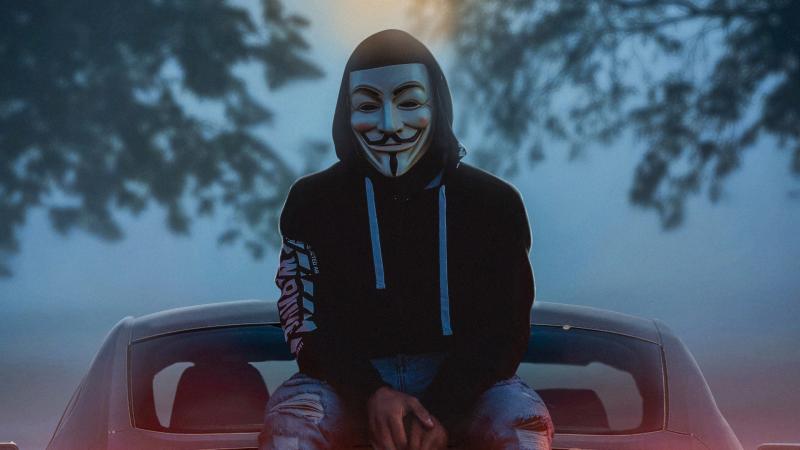 Man Wearing Guy Fawkes Mask While Sitting On Car 4k