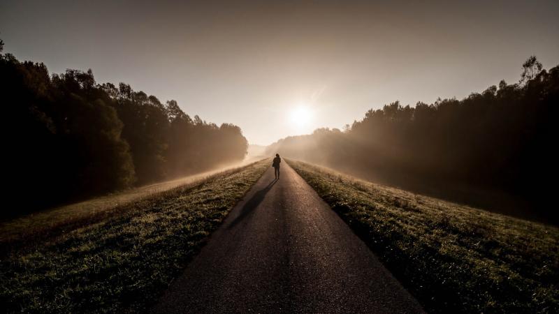 Person Standing Between Road