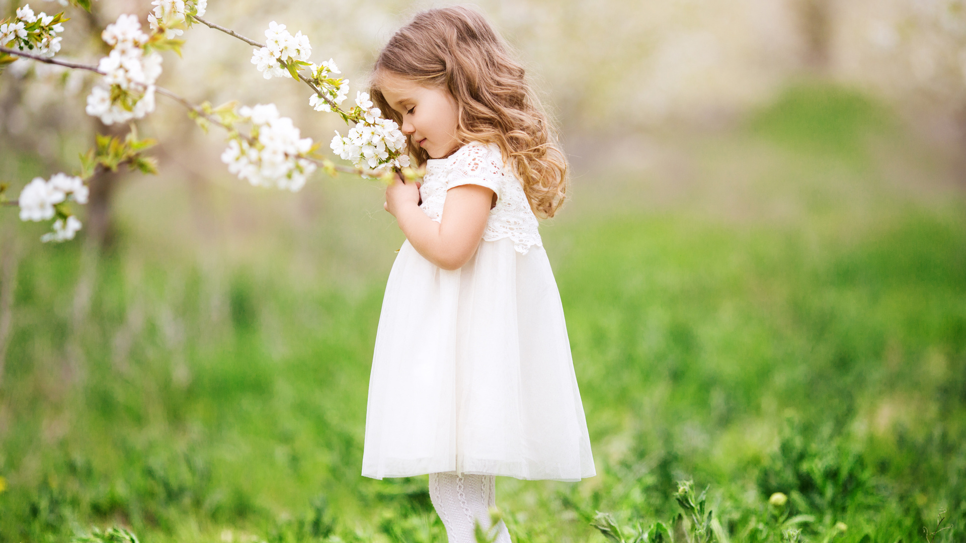 Little Cute Girl Smelling Flowers